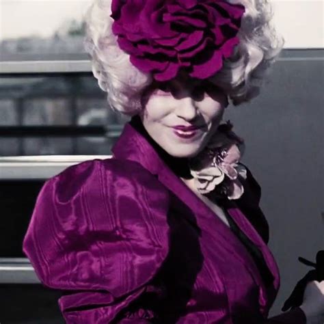 A Woman With White Hair Wearing A Purple Dress And Holding A Flower In