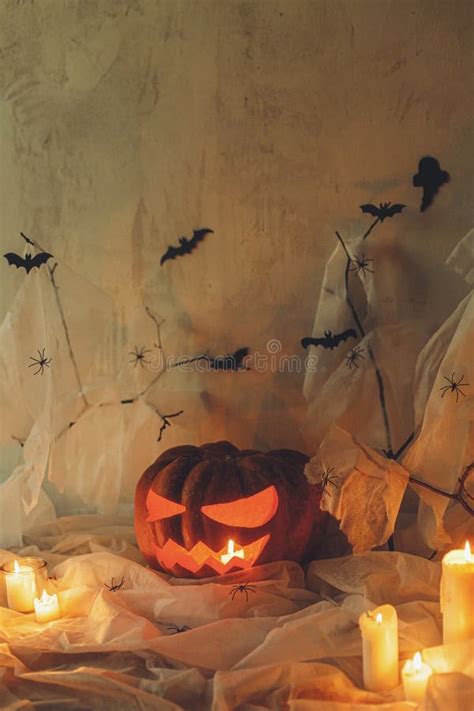 Spooky Jack O Lantern Carved Pumpkin Spider Web Ghost Bats And Glowing Candles In Evening