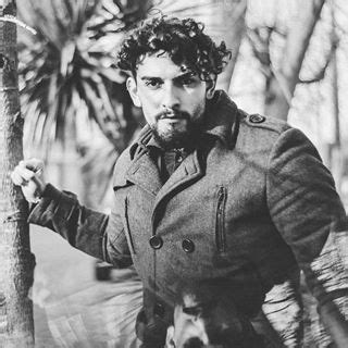 Black And White Photograph Of Man Leaning On Tree