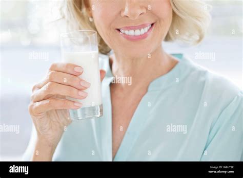 Mature Woman Smiling With Glass Of Milk Stock Photo Alamy