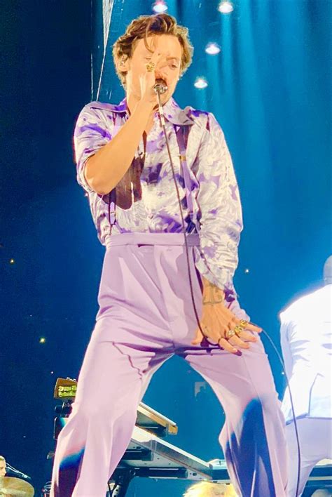 A Male In A Purple Outfit Is On Stage