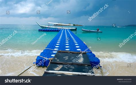 plastic floating pontoon bridge construction passing stock photo