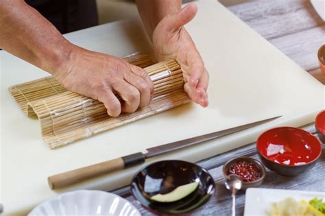 Premium Photo Male Hands Hold Bamboo Mat Knife Lying Near Bamboo Mat