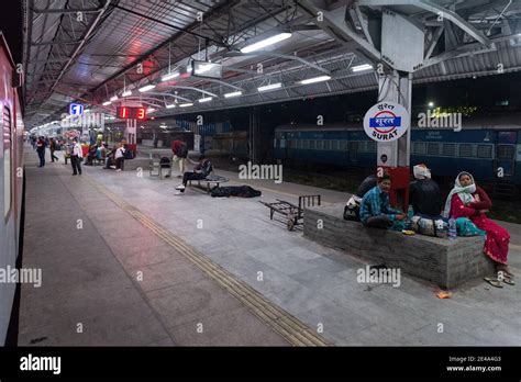 Night scene of Surat Railway Station with people waiting to board their respective trains Stock ...