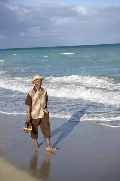 Man walking barefoot on beach Free Photo Download | FreeImages