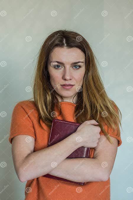 Young Beautiful Girl With Long Hair Teacher With Glasses With A Book In