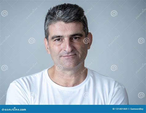 Portrait Of A Attractive Mature Man Looking Neutral Relaxed And Serious