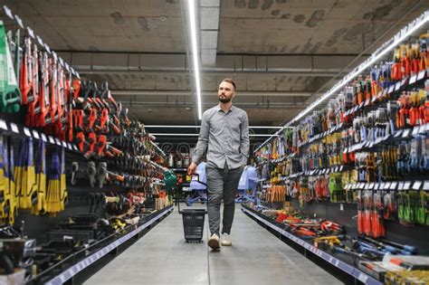 Portrait Of Happy Mature Man Standing In Hardware Store Stock Photo
