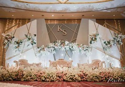 Elaborately Decorated Wedding Reception Stage with Flowers and Greenery