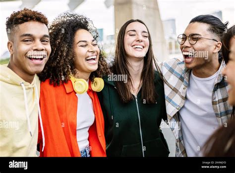 Multiracial Group Of Young Friends Having Fun Together Outdoors Stock