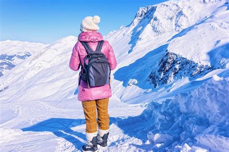 Premium Photo Woman With Backpack Looking At Snowy Slopes Of