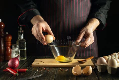 Experienced Chef Trying To Crack An Egg To Prepare A Delicious Breakfast Working Environment In