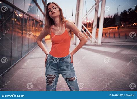 Beautiful Tourist Girl Walking In Busy City Street Near The Airport