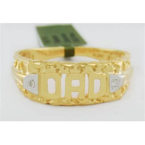 A Gold Ring With The Word Dad Engraved On It