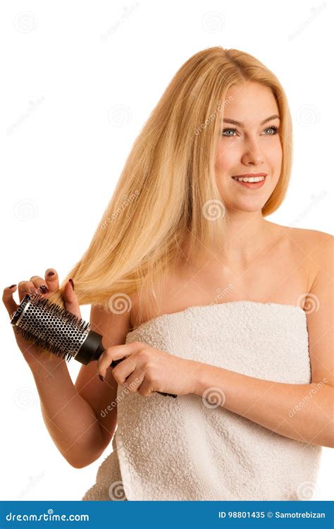 Beautiful Blonde Woman Brushing Her Hair As A Sign Og Hair Care Stock