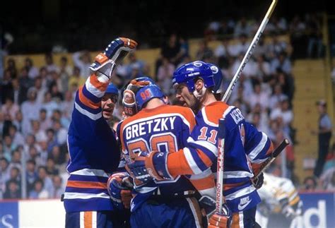 Jari Kurri And Mark Messier Of The Edmonton Oilers Congratulate