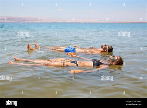 People floating in The Dead Sea, Jordan Stock Photo - Alamy