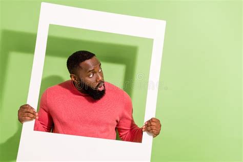 Photo Of Impressed Shocked Man Hold Photo Frame Look Interested Empty