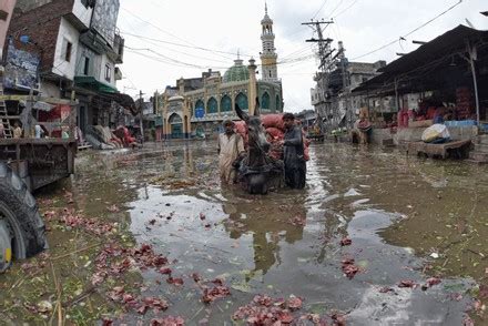 Pakistani People Wade Through Flooded Road Editorial Stock Photo