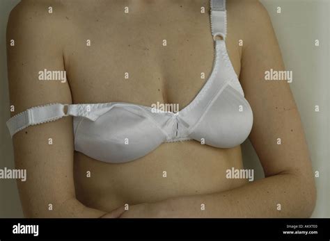 A Woman S Upper Body With A Bra Strap Falling Off Her Shoulder Stock