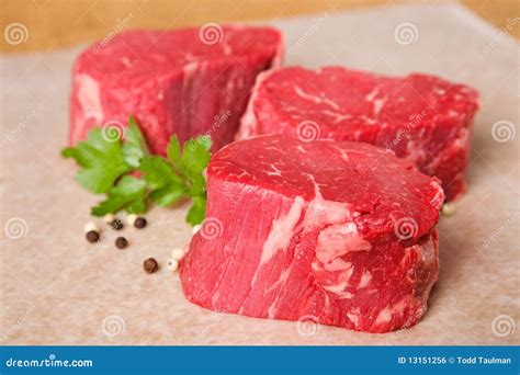raw beef tenderloin   glass baking dish  root vegetables ready