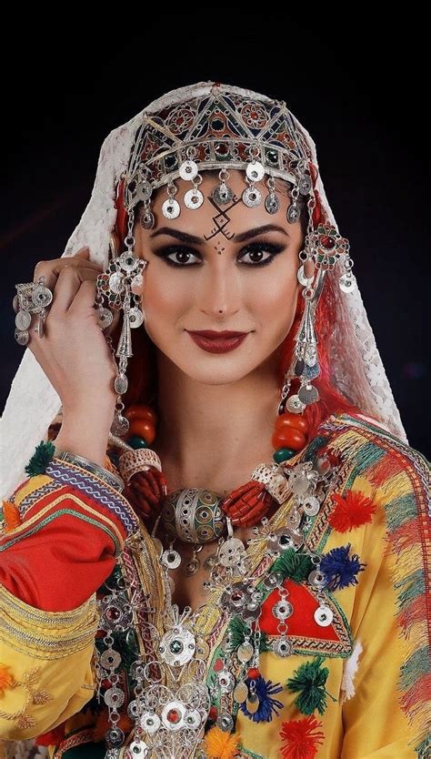 A Woman Wearing An Elaborate Headdress And Jewelry