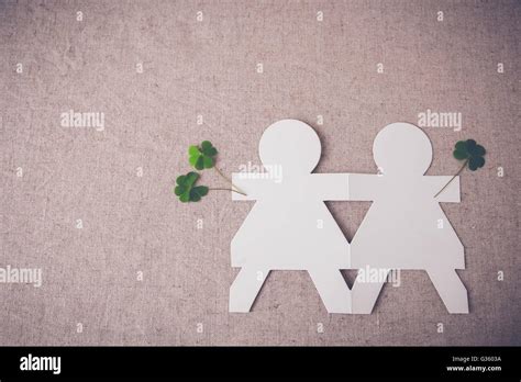 Paper Dolls Holding Hands With Green Leaves Stock Photo Alamy