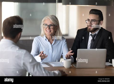 Smiling Hr Managers Holding Interview With Good Job Applicant Stock