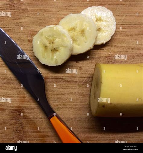Sliced Banana With Orange Knife Stock Photo Alamy