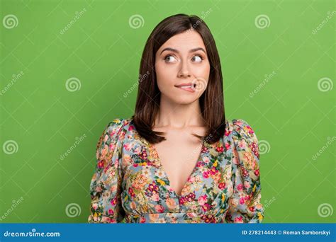 Photo Of Nice Minded Lady Biting Lips Look Interested Empty Space Contemplate Isolated On Green