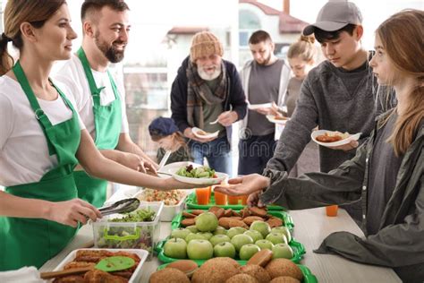 Volunteers Giving Food To Poor People Stock Photo Image Of Altruism