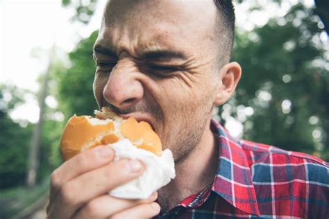 Premium Photo Man Is Eating In The Park And Enjoying Delicious Food