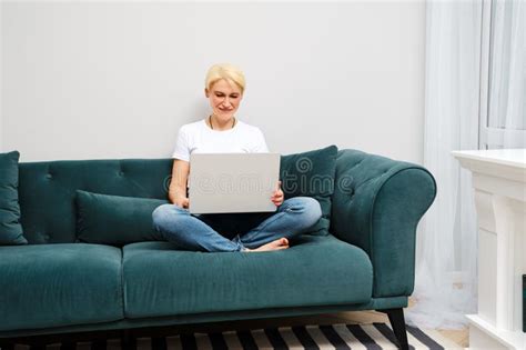 Mature Woman Relaxes On Sofa While Watching Movies Stock Image Image Of Technology