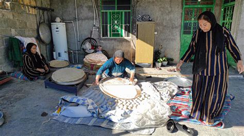 Iranian Nomadic Women Baking Bread In The Courtyard Of A Village House