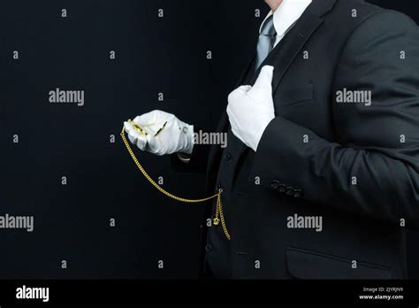 Profile Portrait Of Butler In Dark Suit And White Gloves Holding Gold