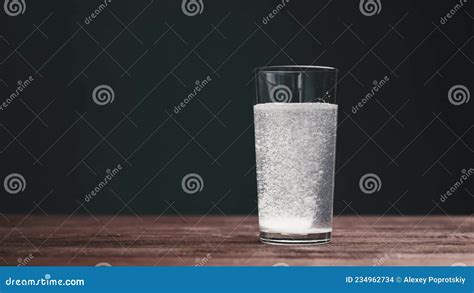 Effervescent Aspirin Pill Falling Into A Glass Of Water Stock Footage