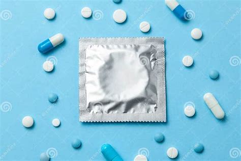 Birth Control Pills And Condom In Package On Blue The Concept Of