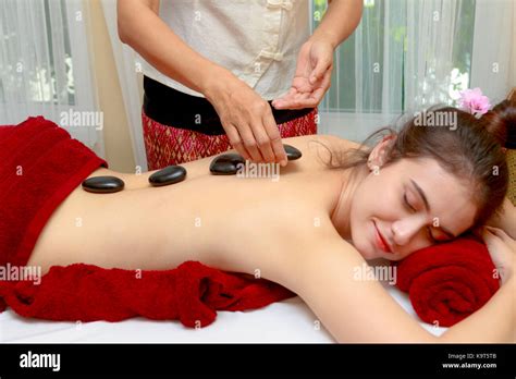 Woman Having Relaxing Hot Stone Massage In Spa Salon Stock Photo Alamy