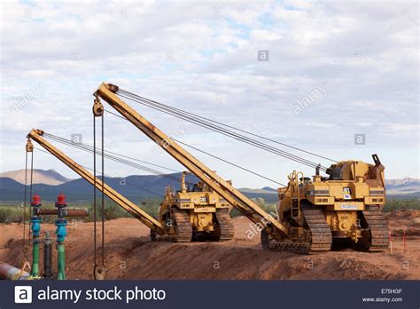 caterpillar cat  sideboom pipelayers holding  foot pipeline