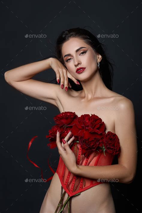 Beautiful Brunette Woman With A Bouquet Of Red Rose Flowers In Red Corset Long Hair Nude Slim