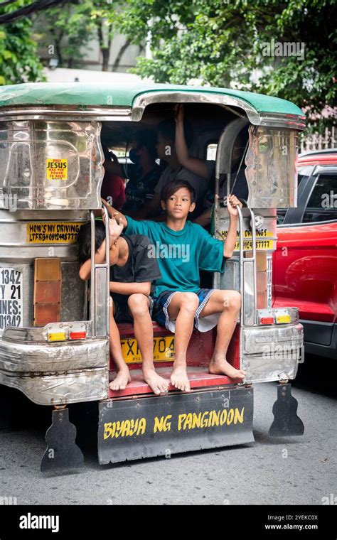 Young Filipino Boys Sit At The Back Of A Jeepney In Manila The