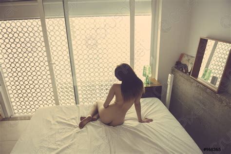 Rear View Of Naked Woman On The Bed In Her Stock Photo Crushpixel