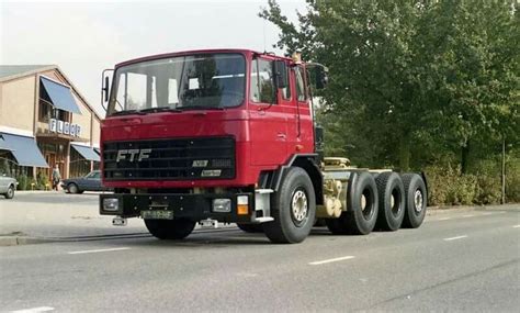 A Red Truck Is Driving Down The Street