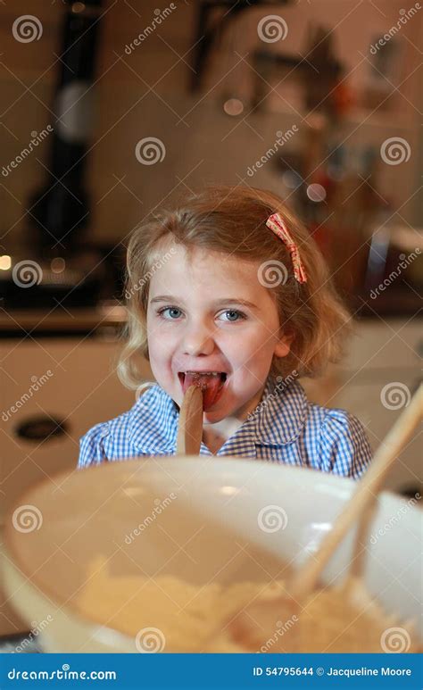 Young Girl Who Has Been Baking Liking The Spoon Stock Photo Image Of