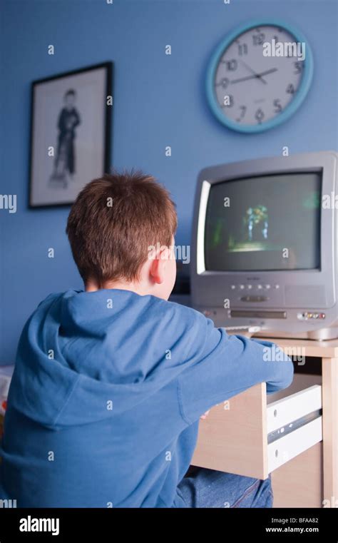 A boy child kid watching tv telly in bedroom hi-res stock photography ...