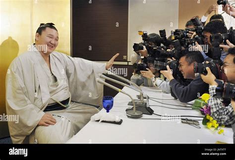 FUKUOKA, Japan - Sumo grand champion Hakuho from Mongolia poses for photographers during a press ...