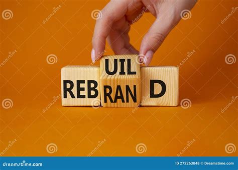 Rebuild And Rebrand Symbol Businessman Hand Turns Wooden Cubes And