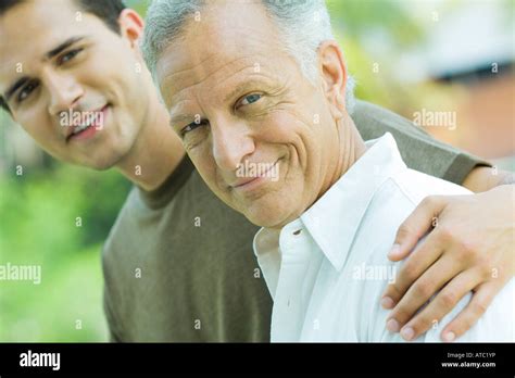 Mature Man And Adult Son Smiling At Camera Together Portrait Stock Photo Alamy