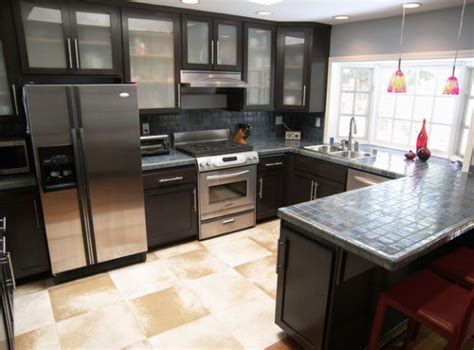 Sleek modern kitchen in black with gorgeous glass cabinets all around ...