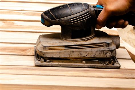 Sanding The Teak Furniture Smooth And Clean With A Sander 13245398